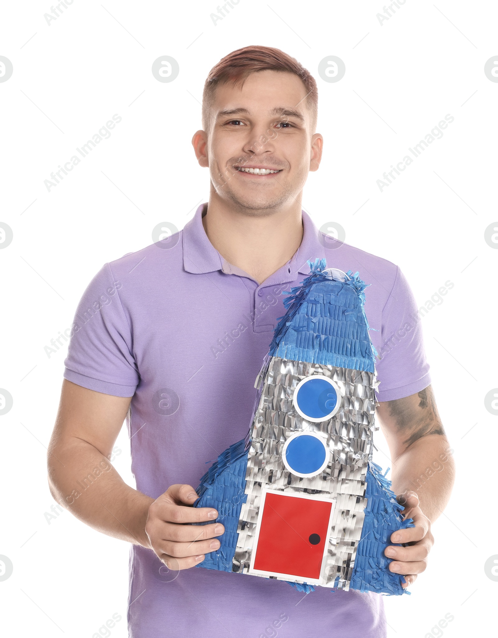 Photo of Happy man with pinata in shape of spaceship on white background