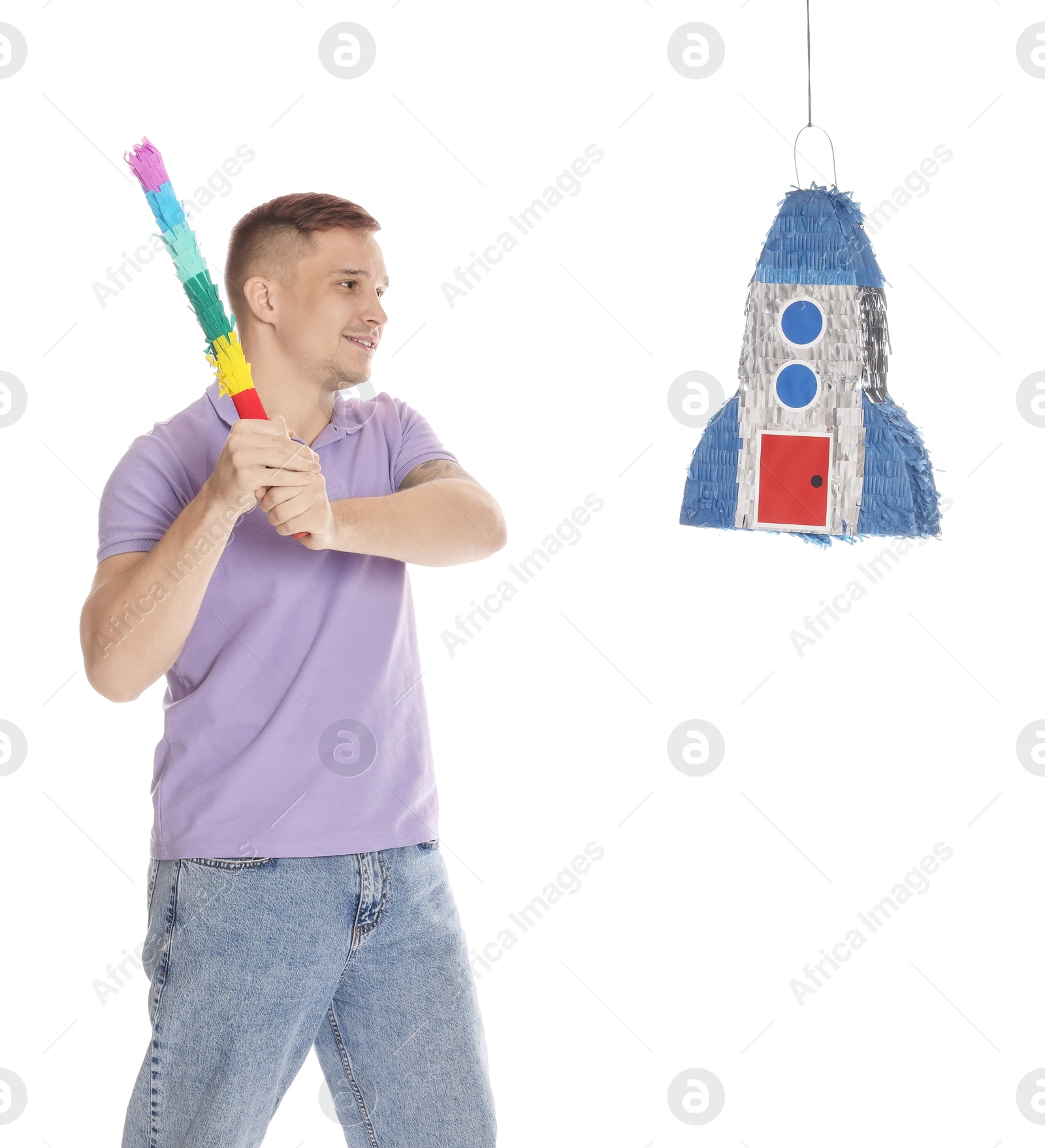 Photo of Happy man breaking pinata on white background