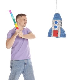 Photo of Happy man breaking pinata on white background