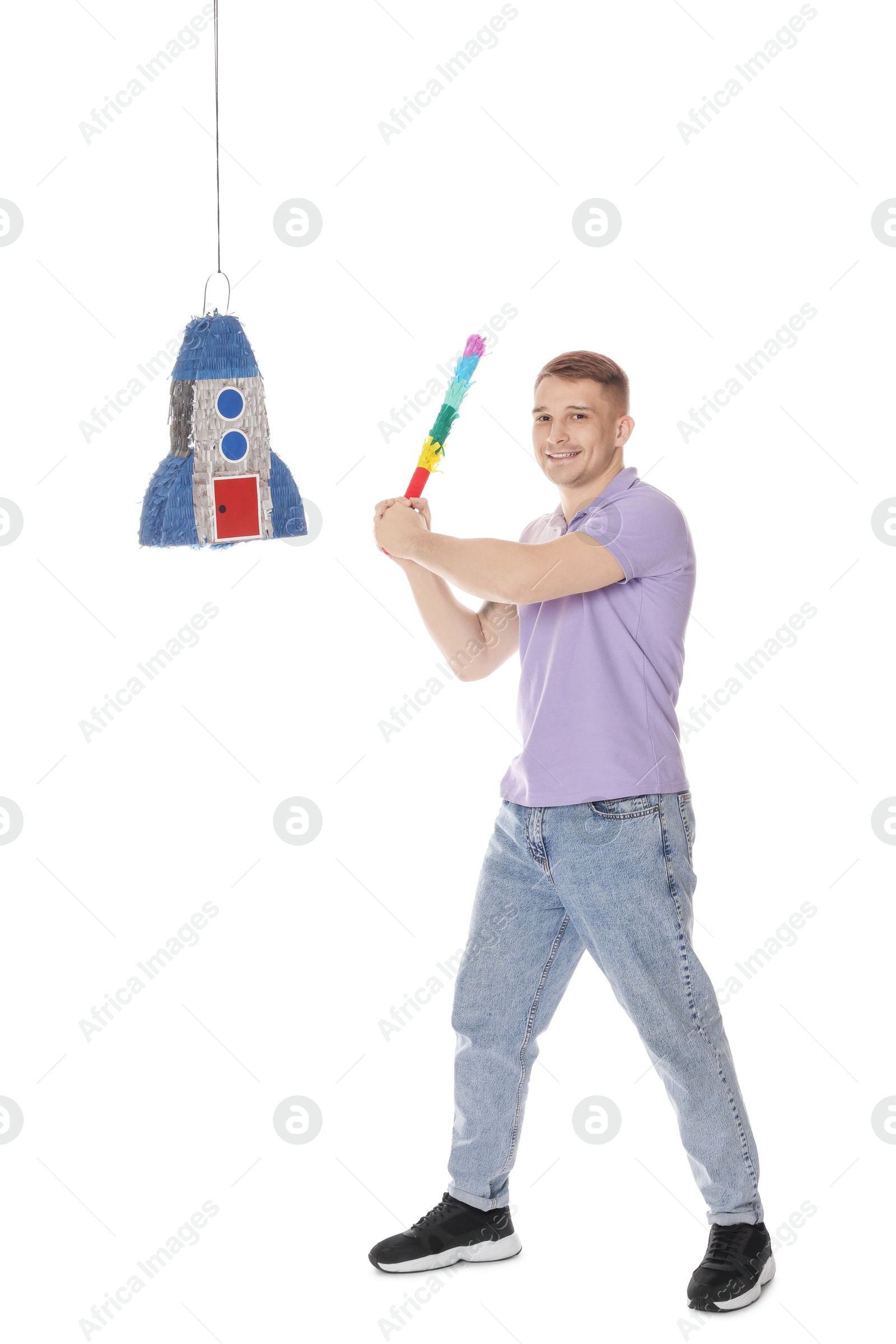 Photo of Happy man breaking pinata on white background