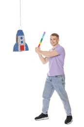 Photo of Happy man breaking pinata on white background