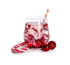 Photo of Tasty Christmas cocktail in glass and red baubles isolated on white