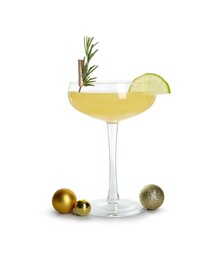 Photo of Tasty Christmas cocktail in glass and baubles isolated on white