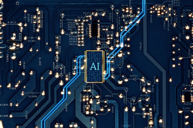 Image of Artificial intelligence. Electronic chip with AI abbreviation on circuit board, top view