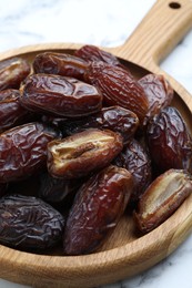 Photo of Many tasty dried dates on light table, closeup