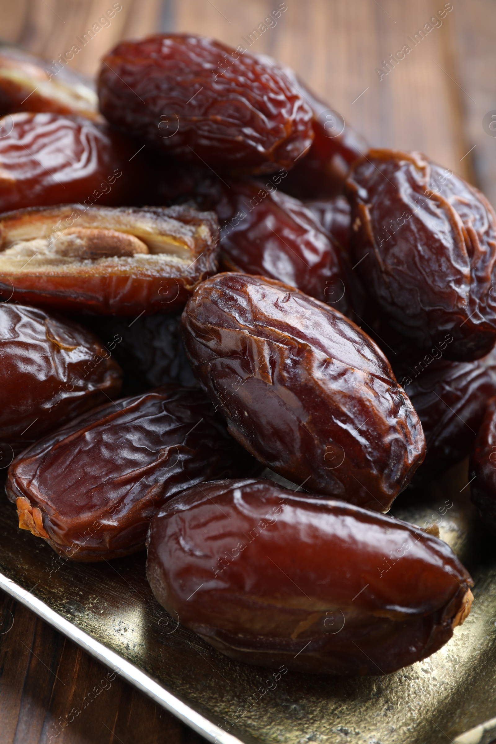 Photo of Many tasty dried dates on wooden table, closeup