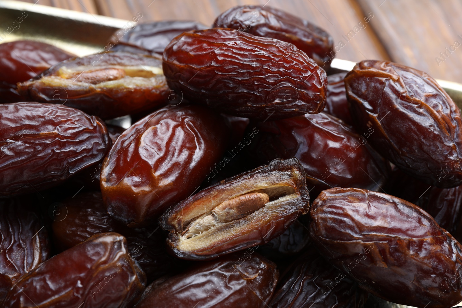 Photo of Many tasty dried dates on table, closeup