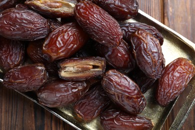 Photo of Many tasty dried dates on wooden table, top view