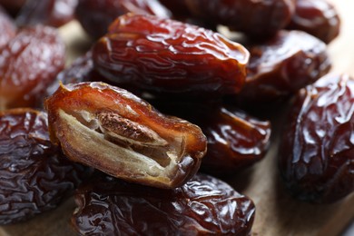 Photo of Many tasty dried dates on table, closeup