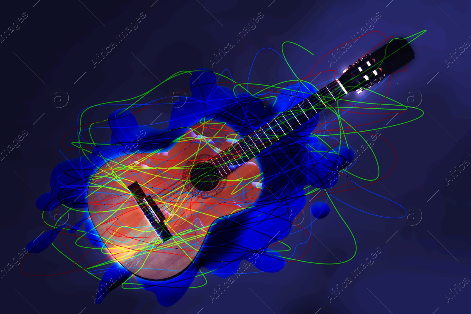 Image of Acoustic guitar with bright scribbles and splash of paint on dark blue background. Creative poster