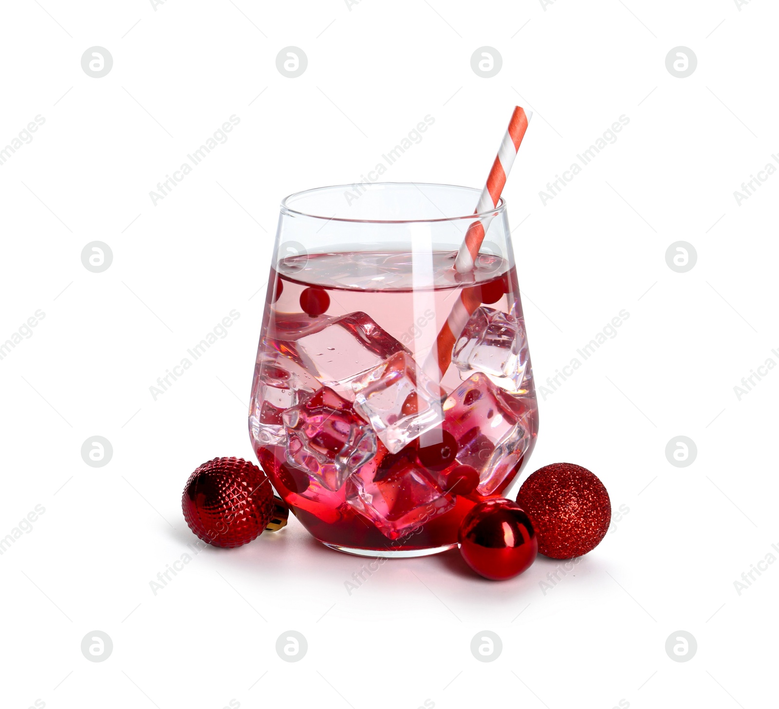 Photo of Tasty Christmas cocktail in glass and red baubles isolated on white