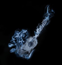 Image of Acoustic guitar in smoke on black background. Creative poster