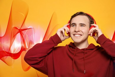 Young man with headphones listening to music on yellow background. Sound waves behind him