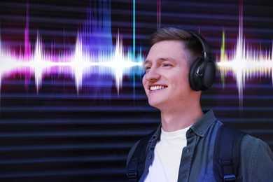 Young man with headphones listening to music outdoors. Sound waves behind him