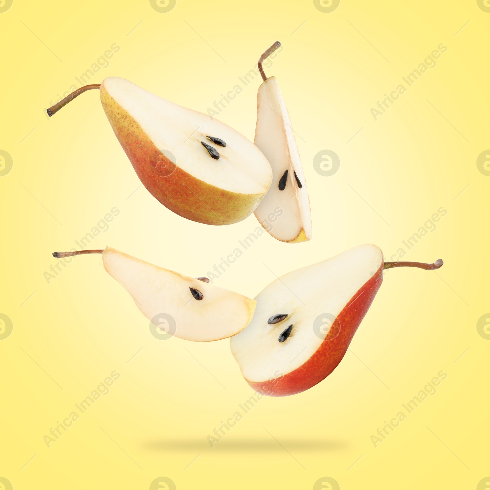 Image of Fresh sliced pears in air on yellow background