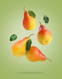 Image of Fresh juicy pears in air on green background