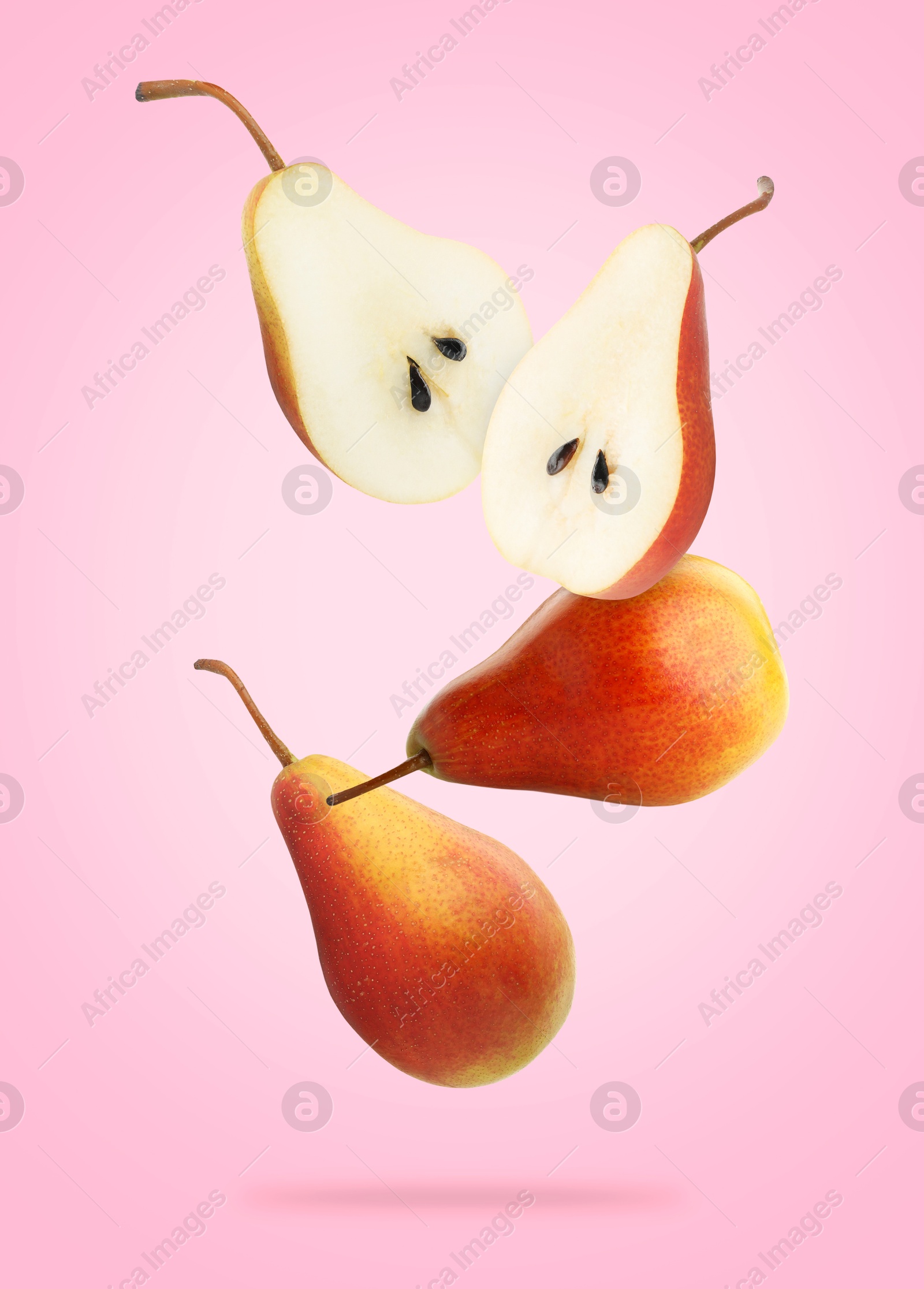 Image of Fresh juicy pears in air on pink background