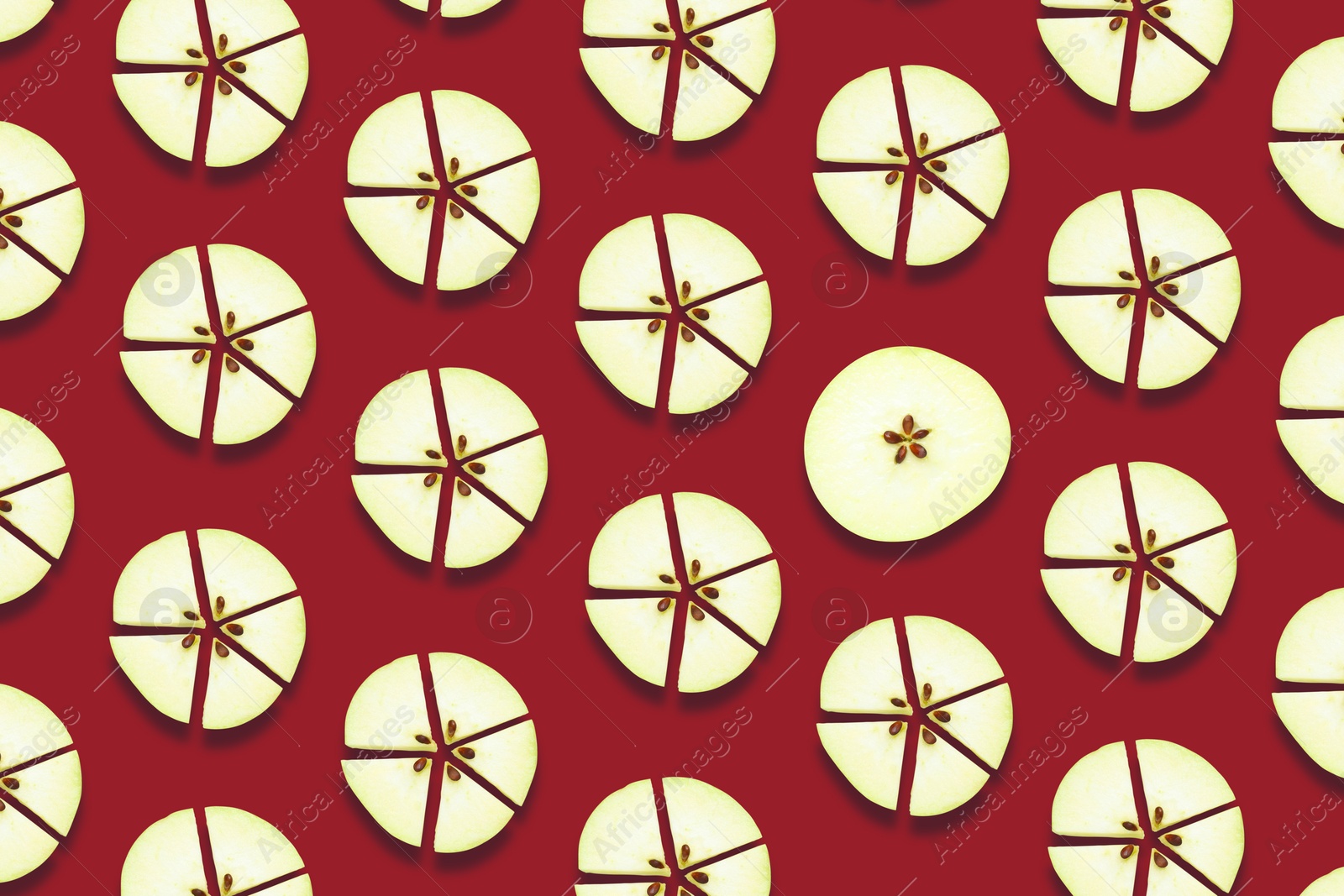 Image of Pattern of fresh apple slices on red background