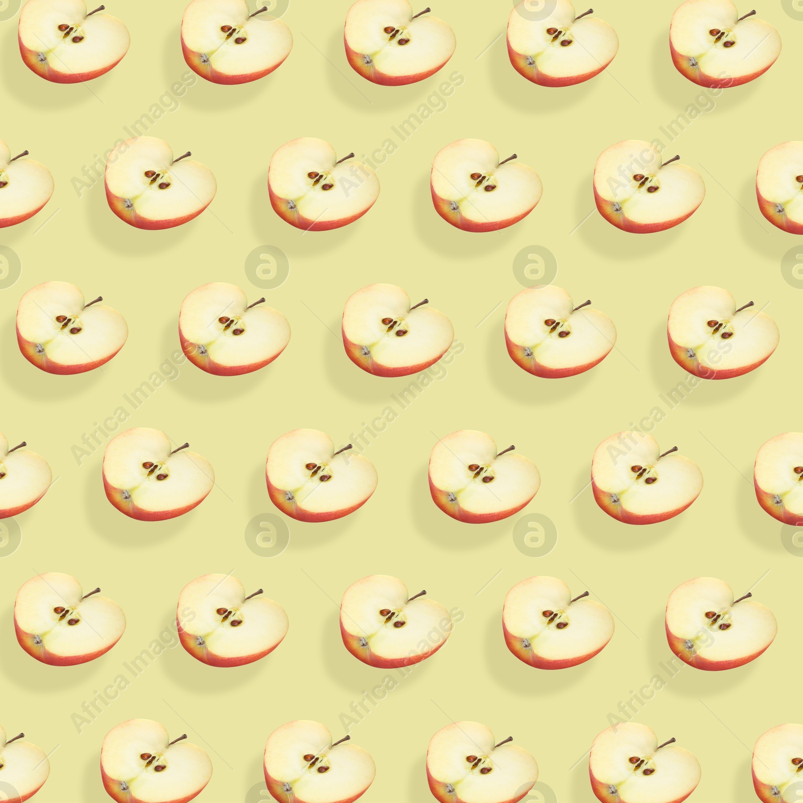 Image of Halves of fresh red apple on beige background, seamless pattern