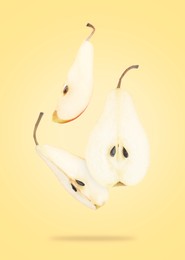 Image of Fresh sliced pears in air on yellow background