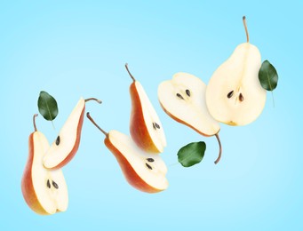 Image of Fresh sliced pears in air on light blue background