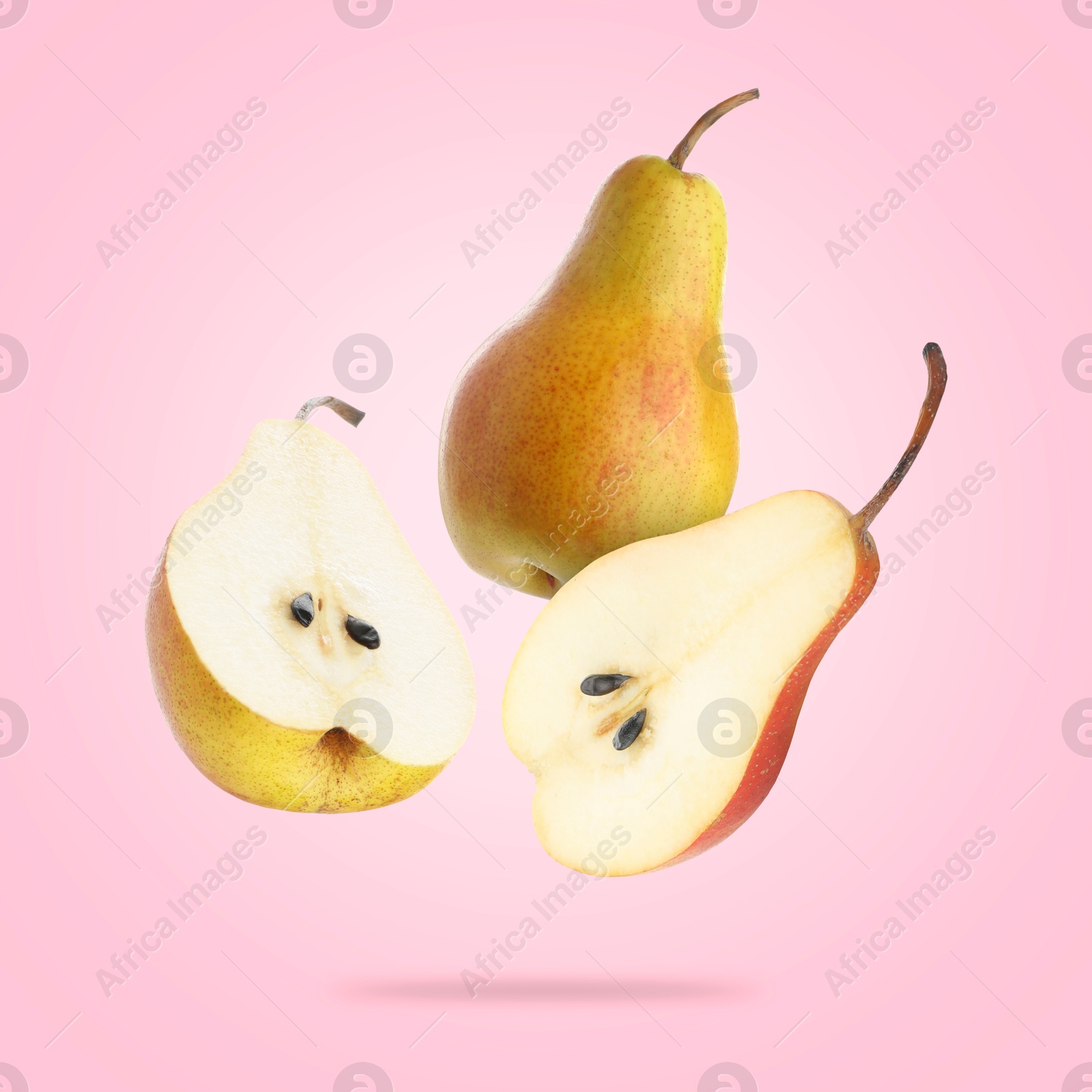 Image of Fresh juicy pears in air on pink background