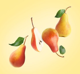 Fresh juicy pears in air on yellow background