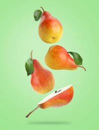 Image of Fresh juicy pears in air on light green background