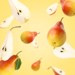 Image of Fresh juicy pears in air on golden background