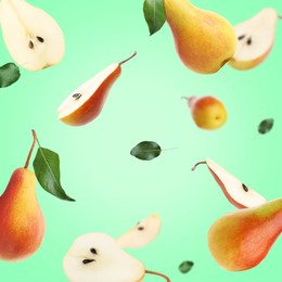 Fresh juicy pears in air on turquoise background