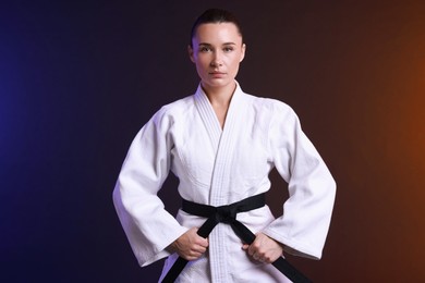 Photo of Karate fighter in kimono on color background