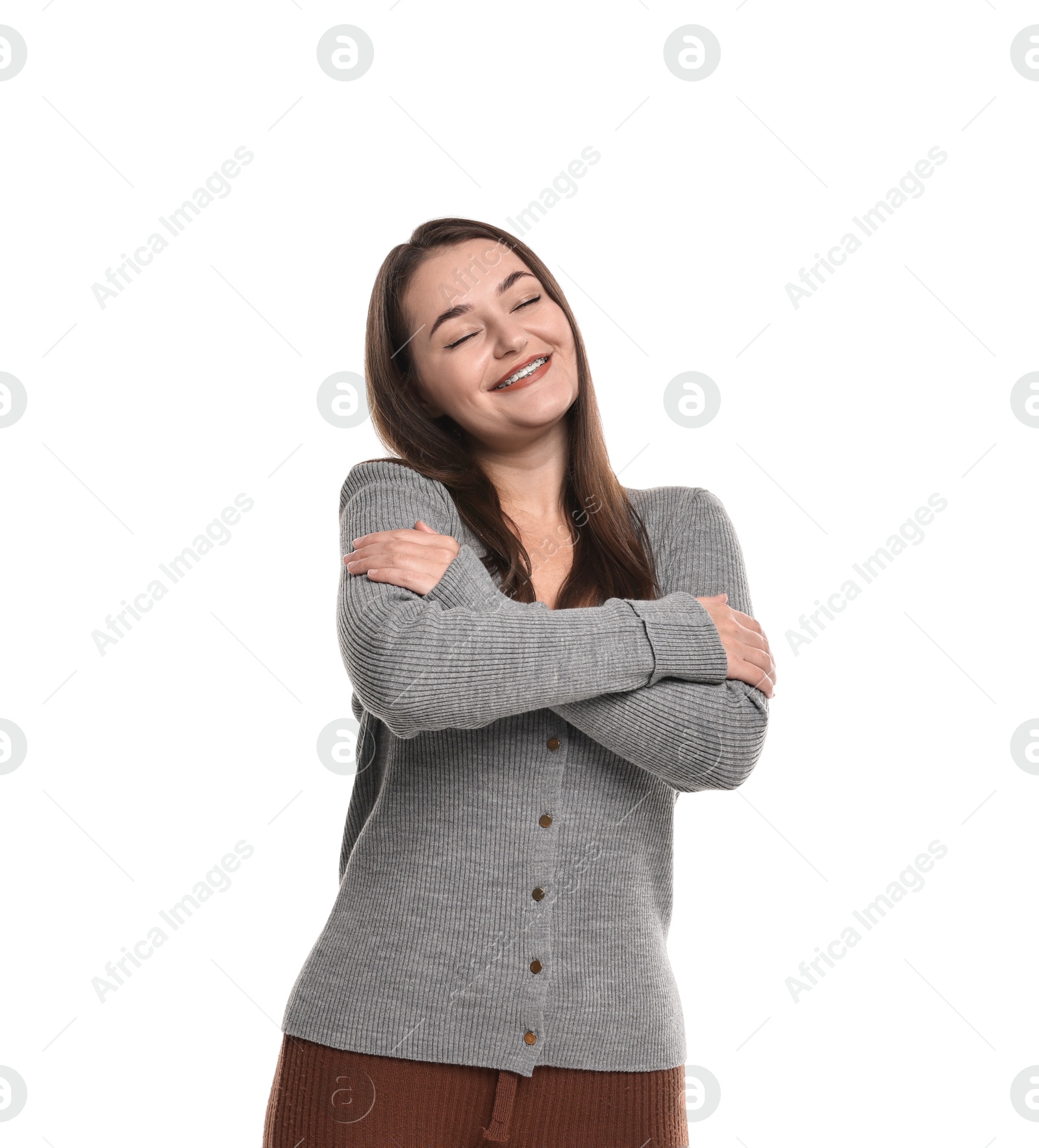 Photo of Beautiful young woman hugging herself on white background