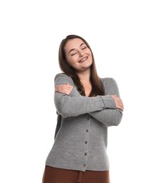 Photo of Beautiful young woman hugging herself on white background