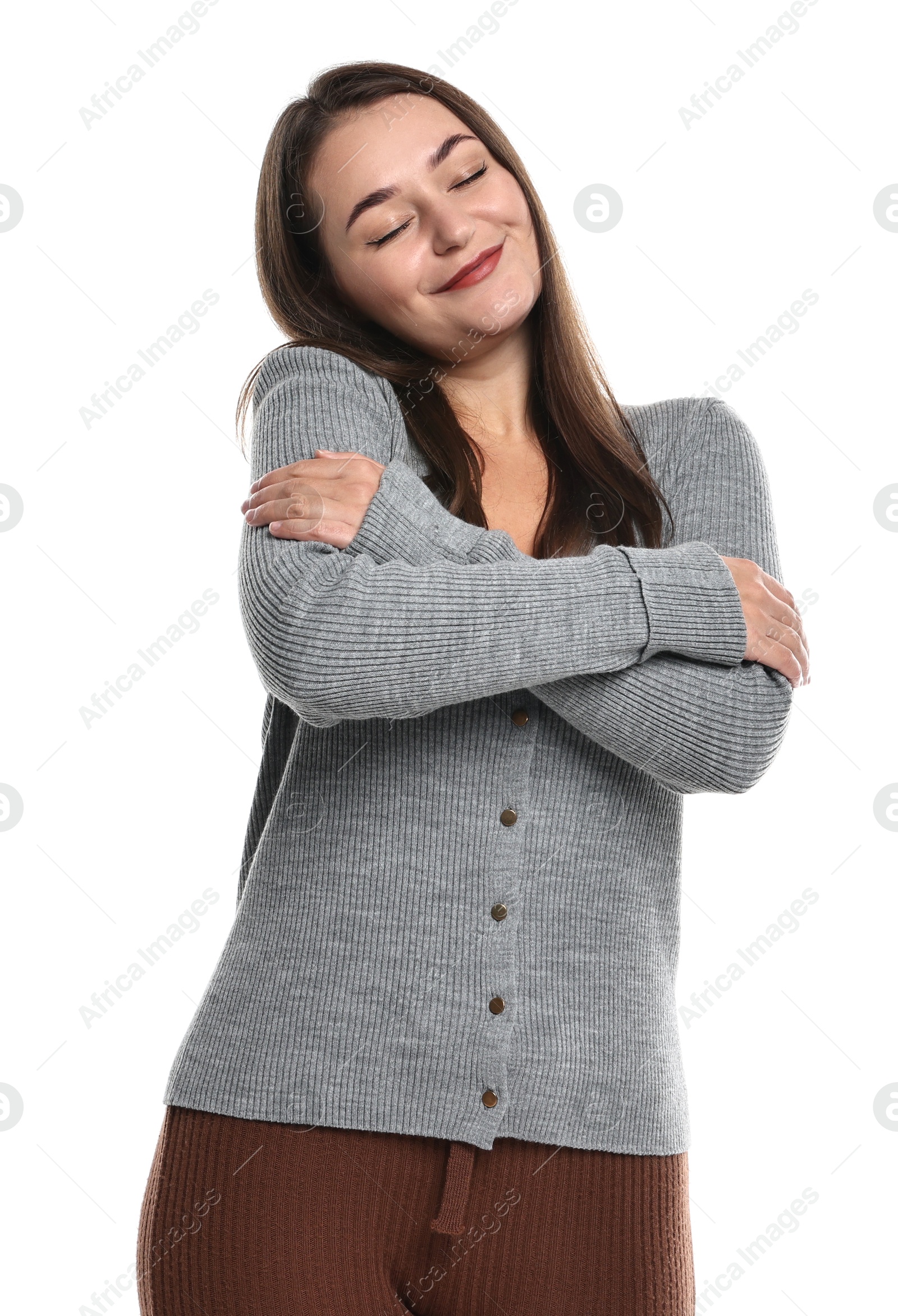 Photo of Beautiful young woman hugging herself on white background