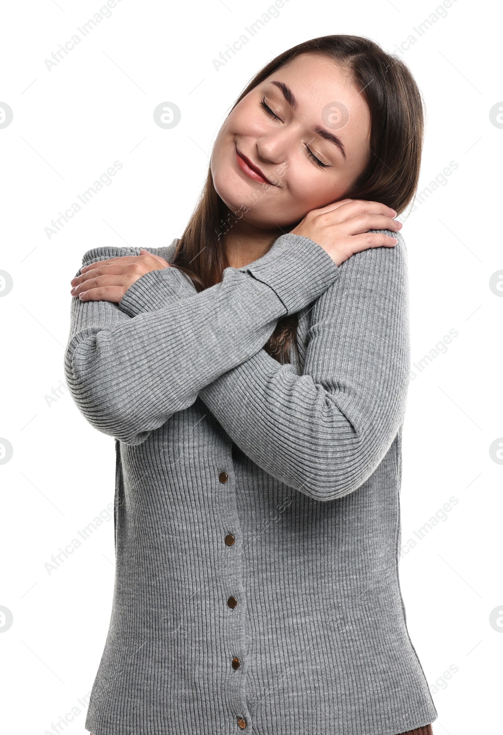 Photo of Beautiful young woman hugging herself on white background