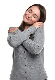 Photo of Beautiful young woman hugging herself on white background