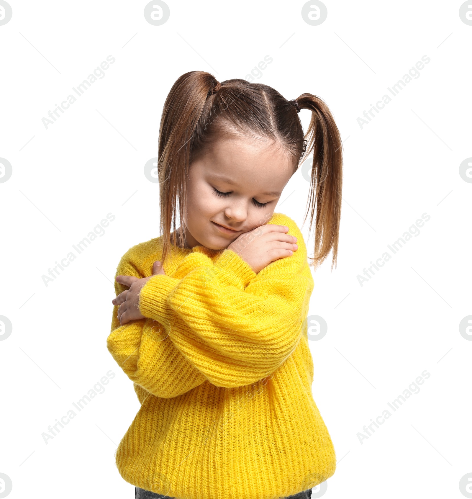 Photo of Cute little girl hugging herself on white background