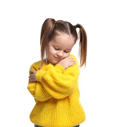 Photo of Cute little girl hugging herself on white background