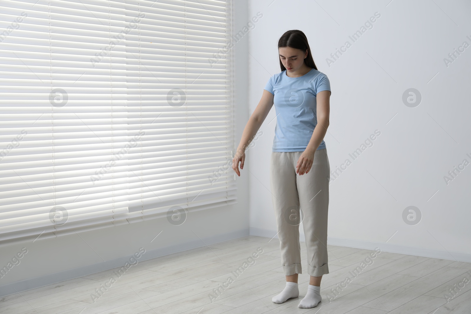 Photo of Young woman suffering from sleepwalking at home, space for text