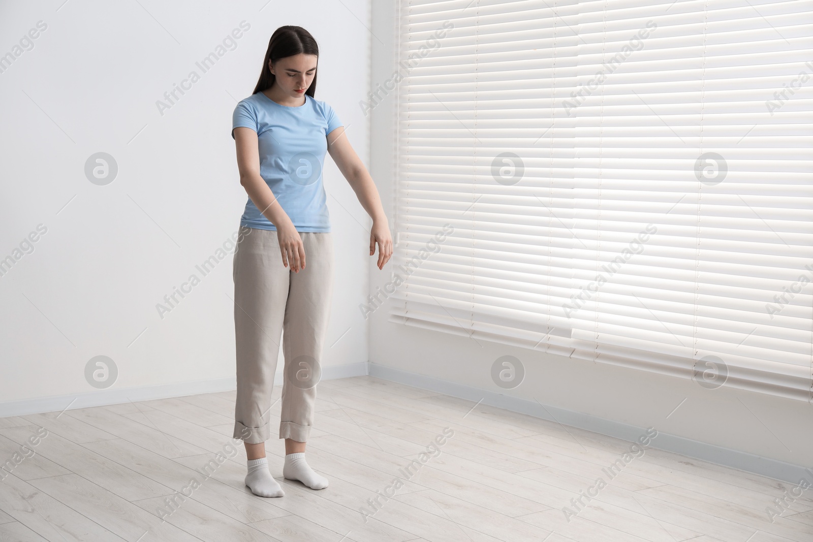 Photo of Young woman suffering from sleepwalking at home, space for text