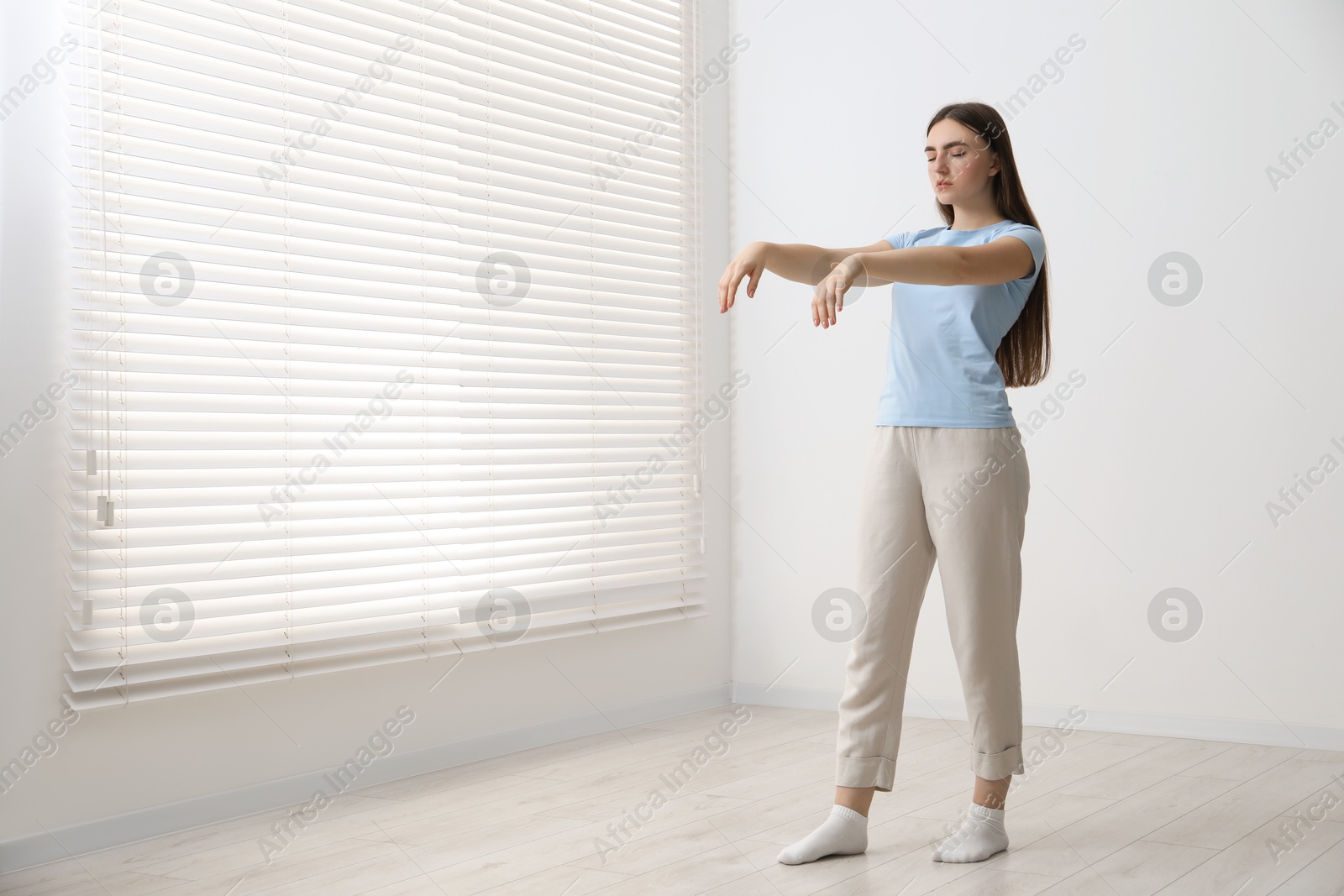 Photo of Young woman suffering from sleepwalking at home, space for text