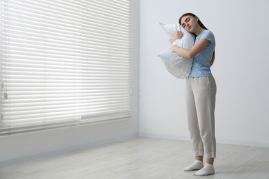 Photo of Young woman suffering from sleepwalking at home, space for text