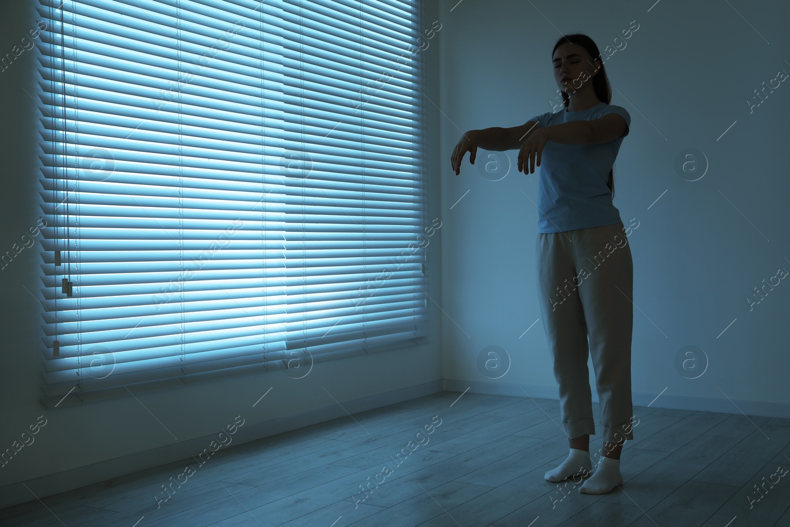 Photo of Young woman suffering from sleepwalking at home, space for text