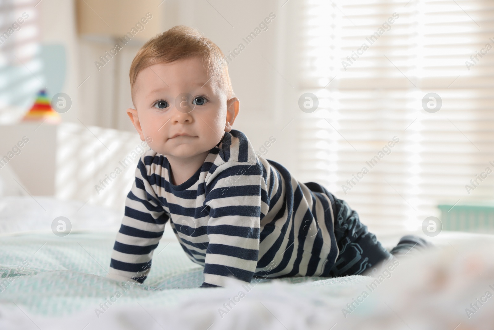 Photo of Cute little baby on bed at home