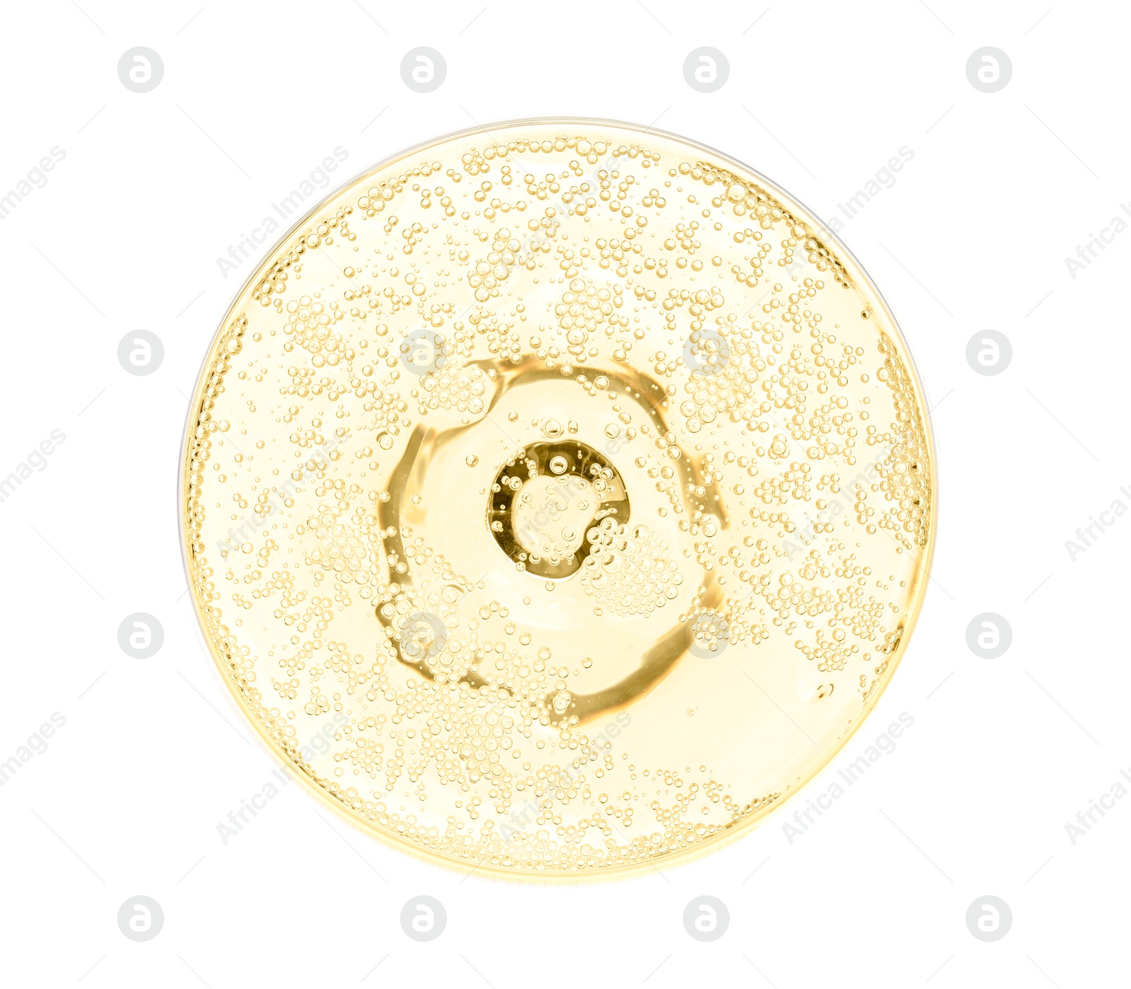 Photo of Champagne in glass isolated on white, top view