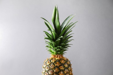 Photo of Fresh ripe pineapple on light grey background, closeup