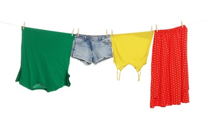 Different clothes drying on laundry line against white background