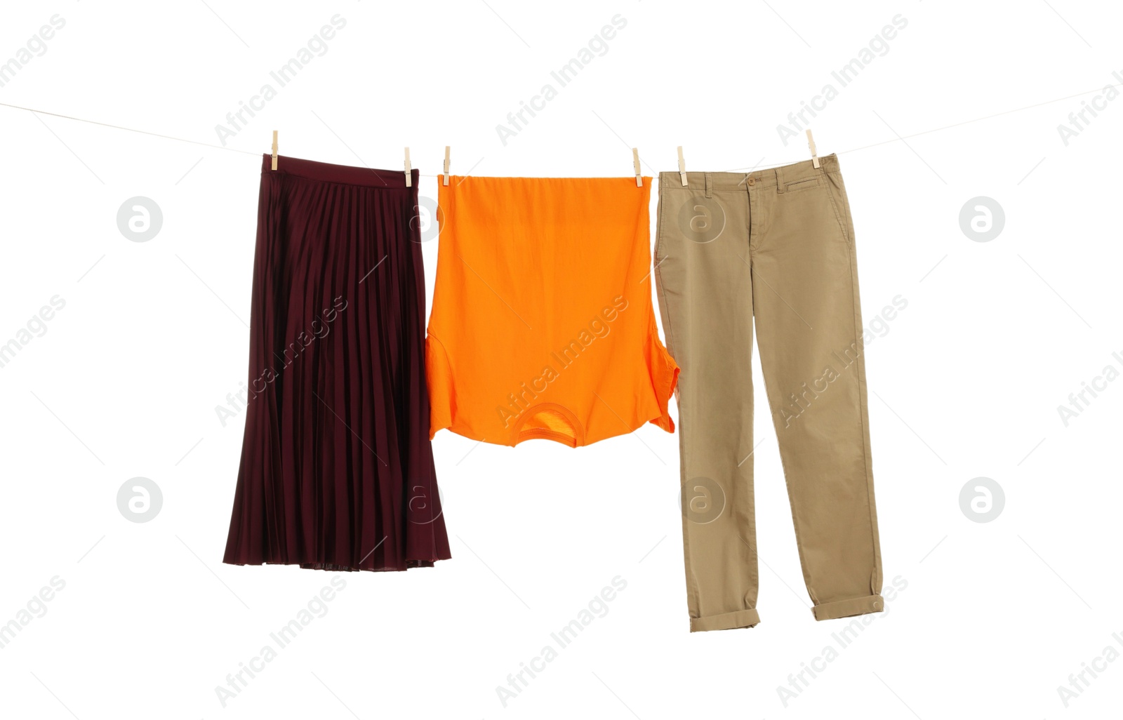 Photo of Different clothes drying on laundry line against white background