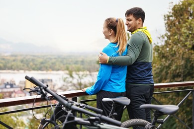 Photo of Beautiful happy couple with bicycles spending time together outdoors