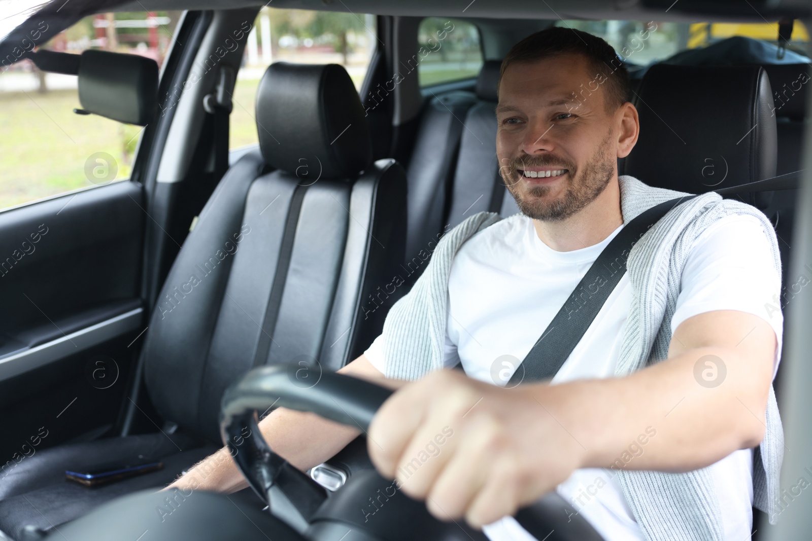 Photo of Man driving modern car, view through window